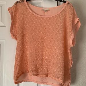 Coral top with fuzzy balls in front